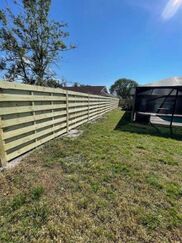 a custom wood fence surrounding a northwest cape coral property