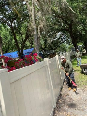pro fence cape coral workers installing a properly permitted fence