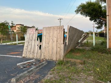 fencing surrounding dumpsters is broken and leaning requiring fence repair company in cape coral fl