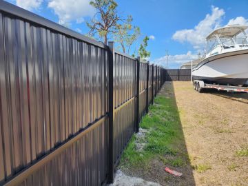 dark brown aluminum privacy fence installation in cape coral keeping boat safe inside property